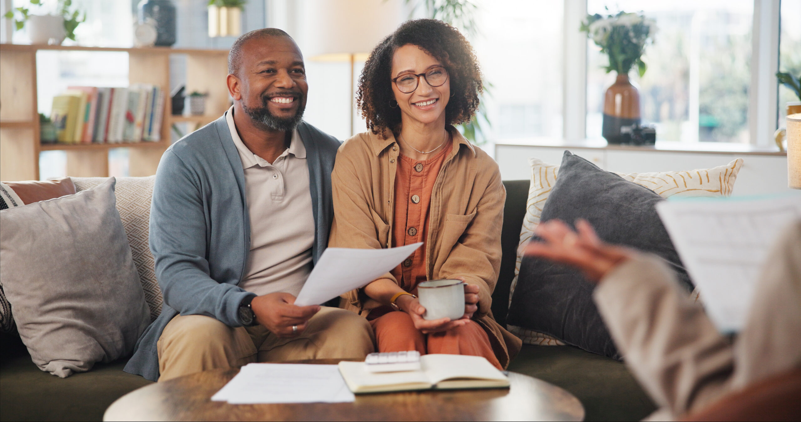 Financial advisor, meeting and mature couple on sofa for estate planning, asset management or pension. Documents, life insurance and retirement paperwork with people at home for investment portfolio.